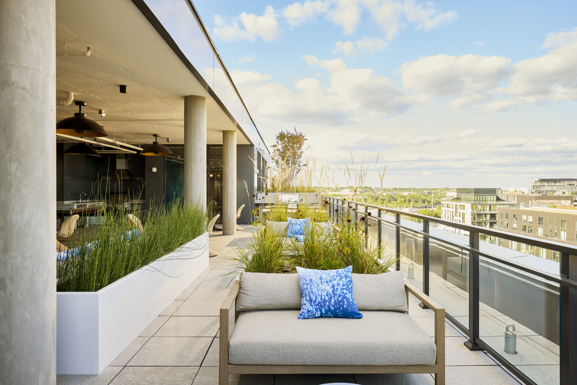 Rooftop lounge area at The 202 in DC, featuring stylish couches and a cozy setting for relaxation.