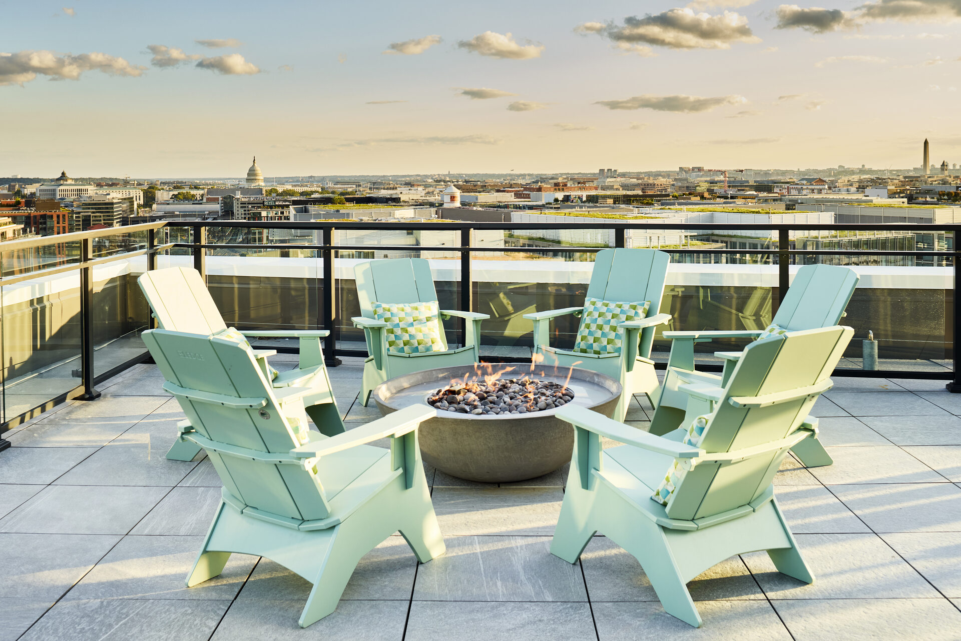 Outdoor firepit area at The 202 in DC, featuring cozy seating arrangements and a warm, inviting atmosphere at sunset.