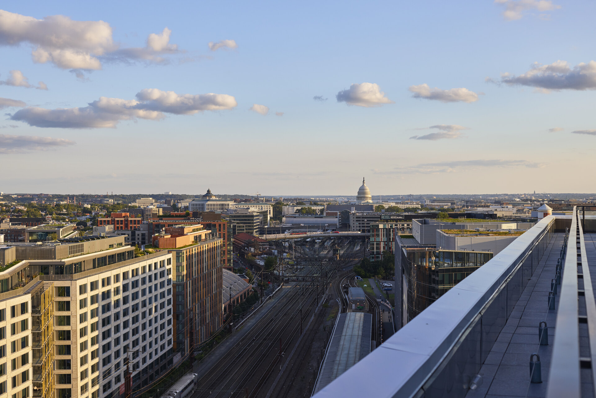 Rooftop outdoor lounge area at The 202 in DC, featuring bright lighting, comfortable seating, and a vibrant atmosphere.