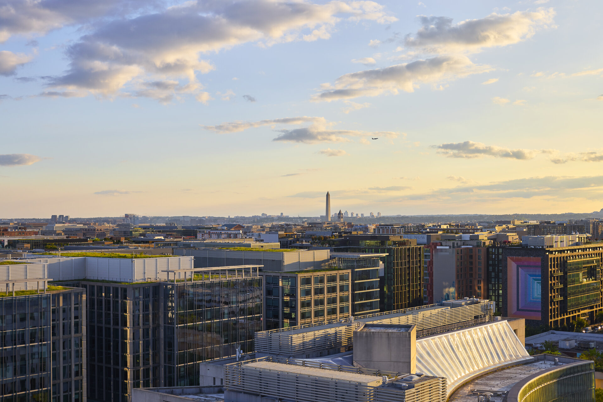 Aerial view of The 202 building in DC at dusk, showcasing its modern architecture and surrounding urban landscape.