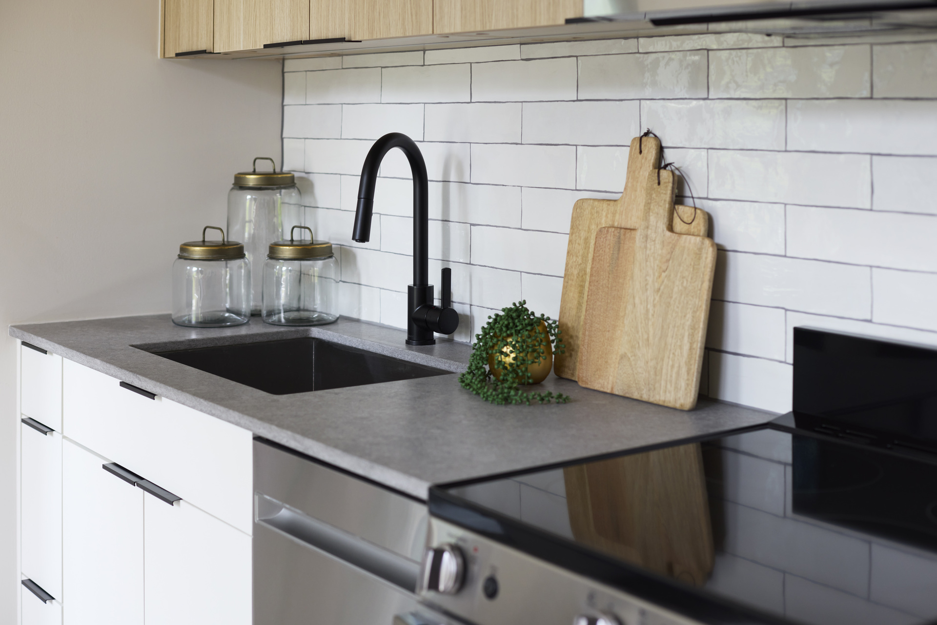 Kitchen sink area in an apartment at The 202 in DC, featuring modern fixtures and stylish countertops.